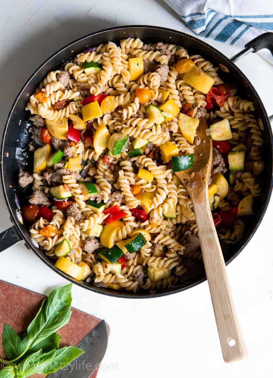 skillet with spiral shaped pasta and vegetables 