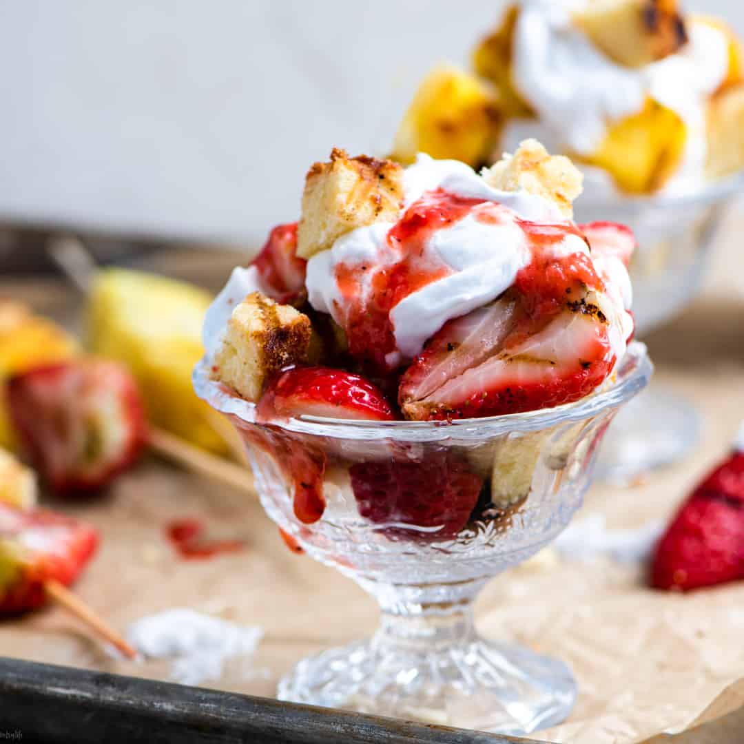 Grilled strawberry shortcake parfait in a glass dish 