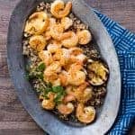 Metal serving plate with healthy cuban mojo shrimp and quinoa