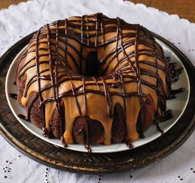 chocolate bundt cake covered with peanut butter and chocolate drizzle