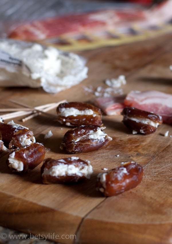 dates stuffed with goat cheese on wooden cutting board