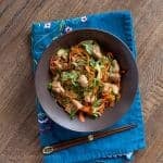 brown bowl of chicken stir fry with veggie noodles
