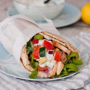 gyro wrap with chicken, cucumbers, and tomatoes