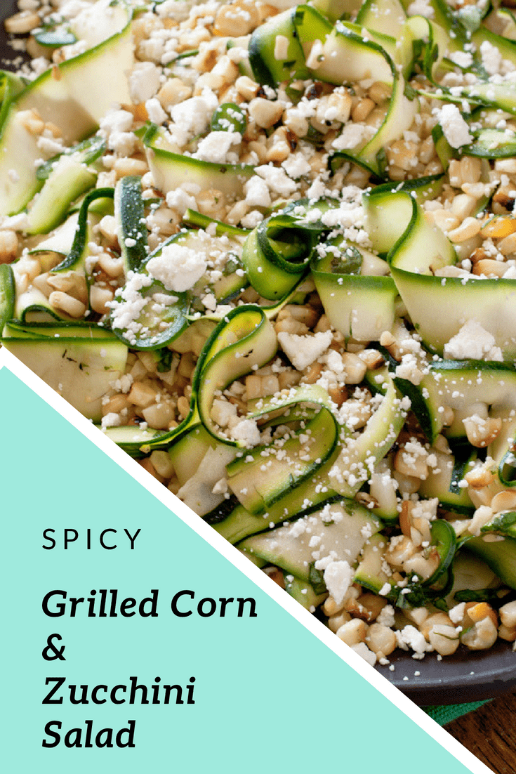 Grilled Corn and Zucchini Salad topped with crumbled feta cheese on a brown oval shaped plate