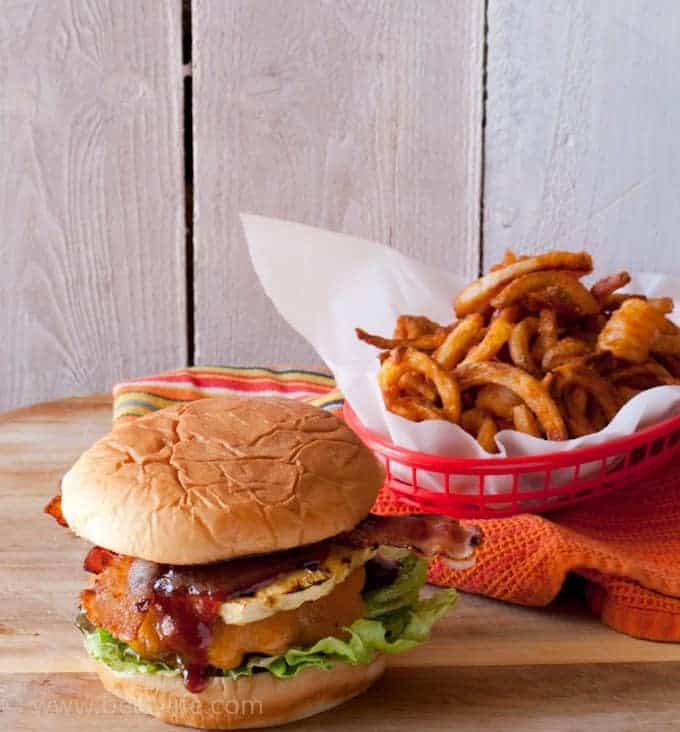 BBQ Bacon Hawaiian Burgers next to a basket of curly fries