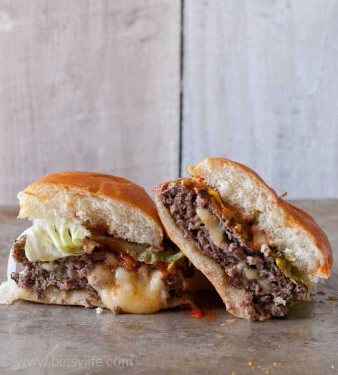 Jalapeno Cheddar Juicy Lucy Burger cut in half showing melted cheese on the inside