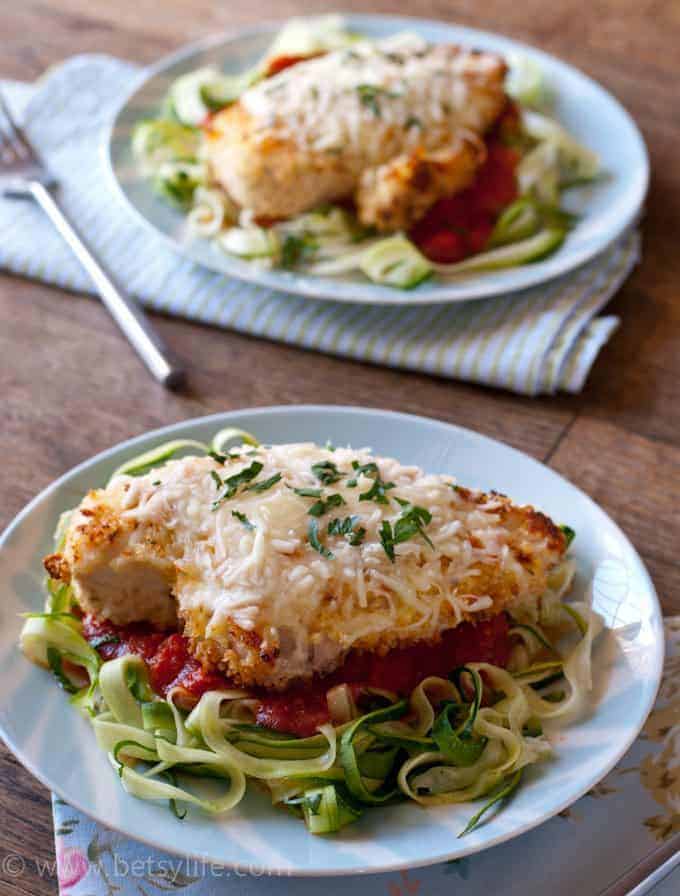 Baked Chicken Parmesan Over Zucchini Noodles on a blue plate 
