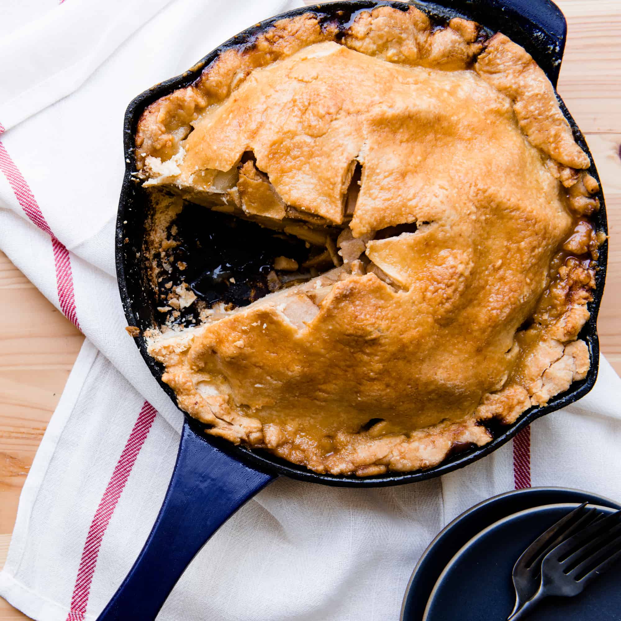 Cast iron skillet apple pie with a slice removed