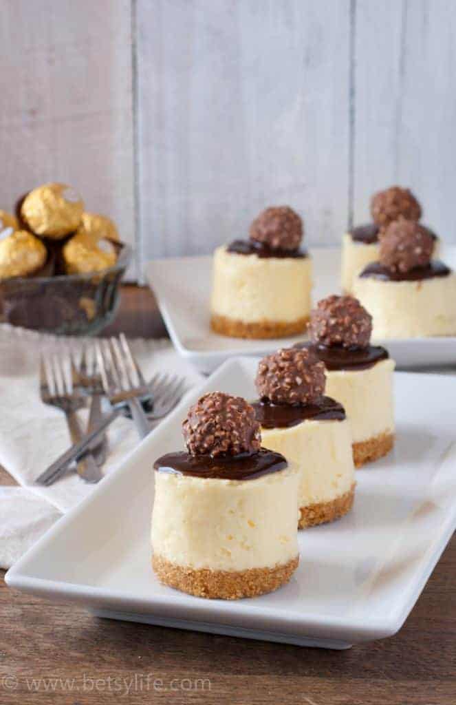 Individual mini Cheesecakes lined up on white plate