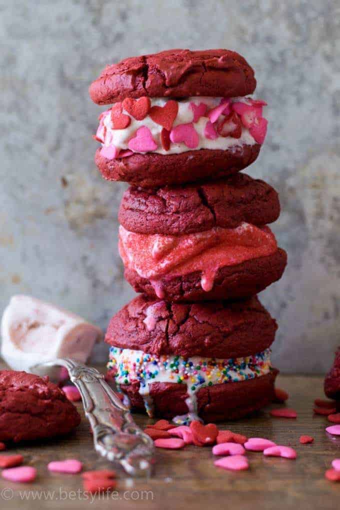 Stack of Red Velvet Ice Cream Sandwiches next to a spoonful of strawberry ice cream 