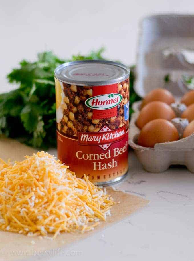 can of corned beef hash next to eggs and shredded cheese