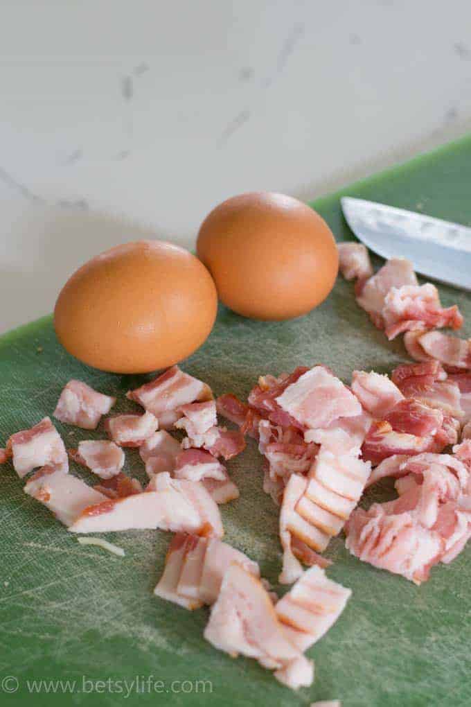 eggs and bacon on a cutting board 