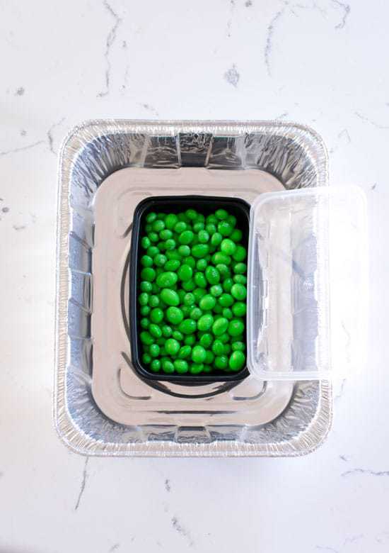 Green M&Ms in the center of a metal baking pan 
