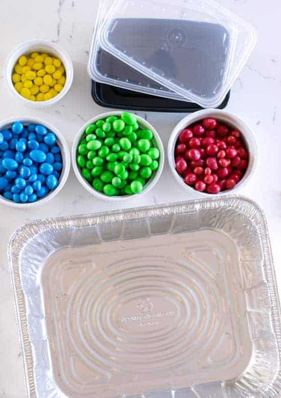 M&ms sorted by color next to a metal baking pan 