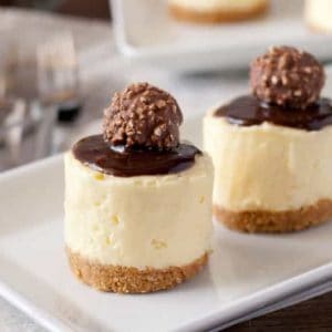 round mini cheesecakes topped with chocolate and truffles