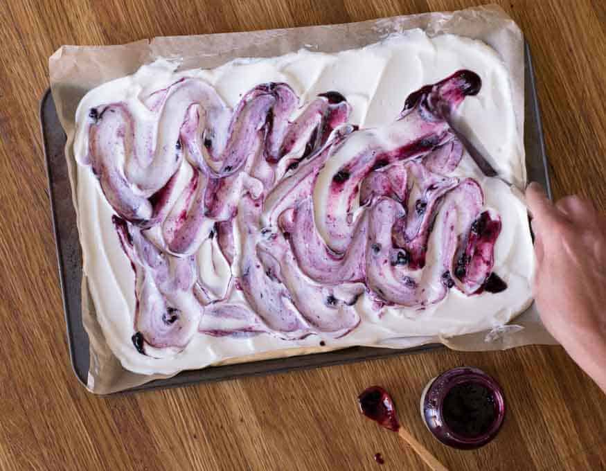 swirling blueberry jam on yogurt