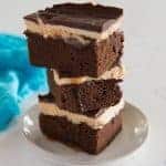 stack of chocolate stout brownies with dripping caramel and Irish cream frosting