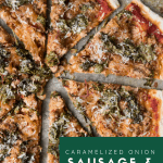 caramelized onion, kale and sausage pizza sliced into triangles on a baking sheet