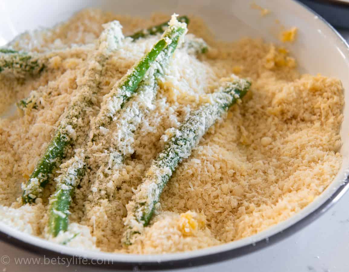 green beans in a bowl of panko bread crumbs