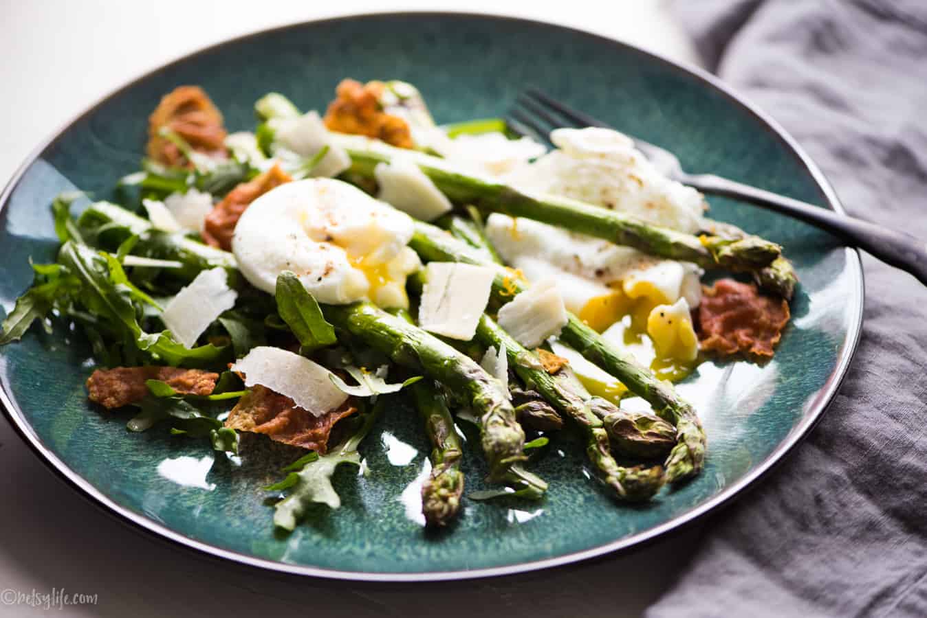 blue plate with roasted asparagus, poached eggs, crispy prosciutto, and shaved parmesan 