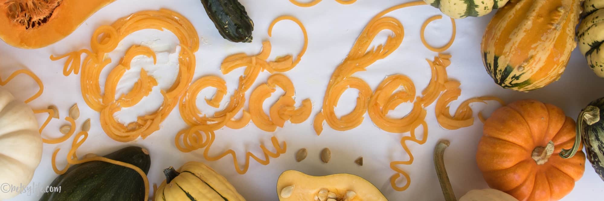 detail of food letters spelling out October with squash and seeds