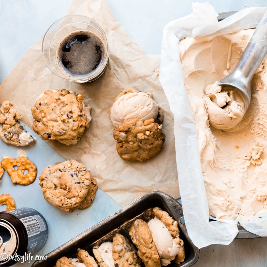 pretzel cookie ice cream sandwiches next to a container of ice cream, a scoop and a beer 